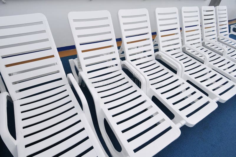 Row of white beach chairs