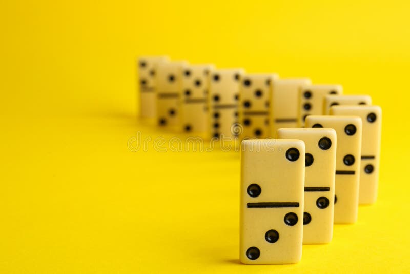 Row of white domino tiles on background. Space for text royalty free stock image