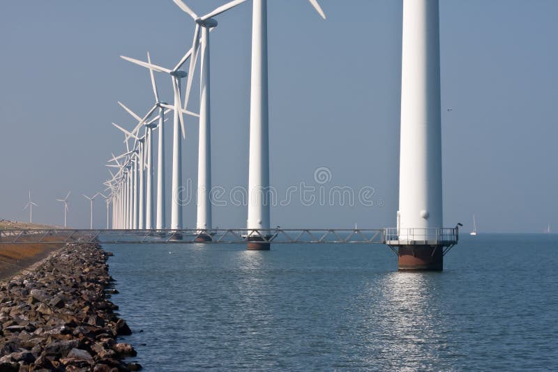 Long row of windmills standing in Dutch sea