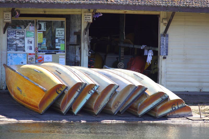 Row boats piled at general store of Australian old timber boathouse