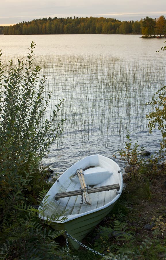 Rowing boat moored by lake stock photo. Image of scenic 11110150