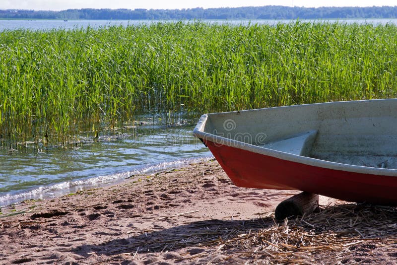 Rowing boat at sea shore stock photo. Image of orange 28130176