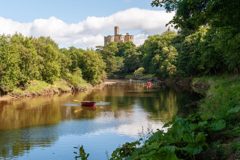 Rowing boats on the River Coquet with Warkworth Castle in the background