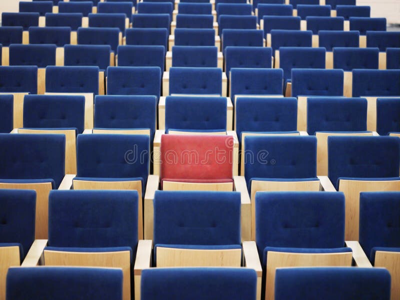 Rows Of Blue Armchairs And One Red