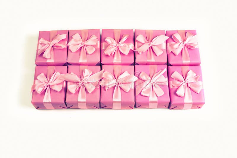 Rows of boxes with gifts decoration ribbon satin bow pink A top view of Flat lay toning. royalty free stock photo Rows of boxes with gifts decoration ribbon satin bow pink A top view of Flat lay toning. royalty free stock photo
