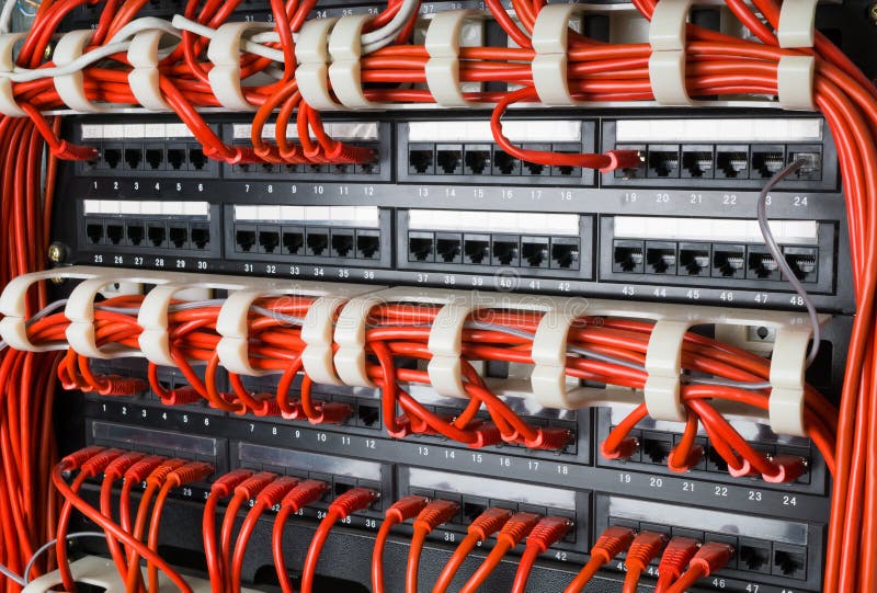 Rows of network cables connected to router and switch hub stock photo