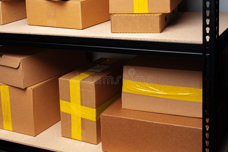 Rows of Shelves with Cardboard Boxes in Modern Warehouse Stock Photo