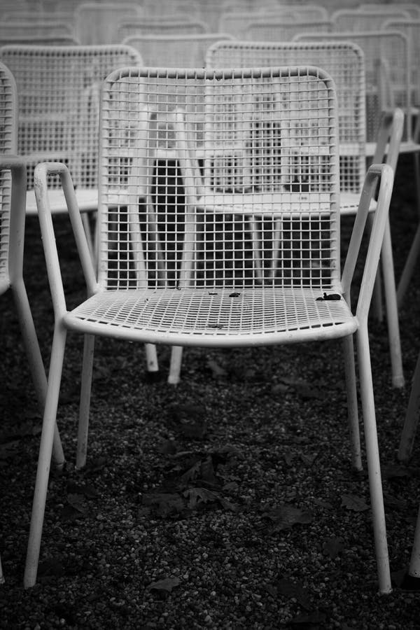Rows of White Metal Garden Chairs in Front of an Outdoor Stage. Stock
