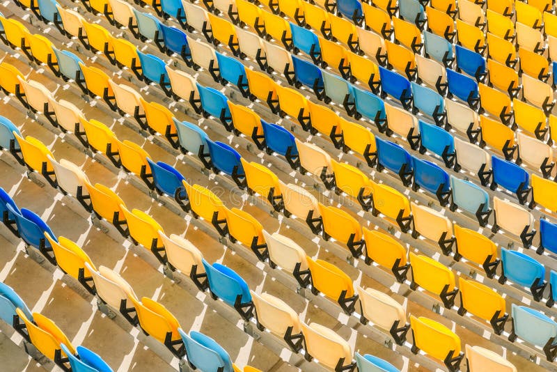 Rows of yellow and blue stadium seats background