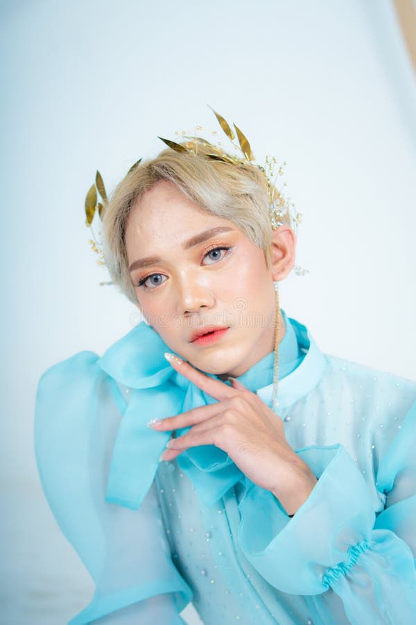 A Royal Princess Posing with a Golden Crown and Blonde Hair Very Cutely ...