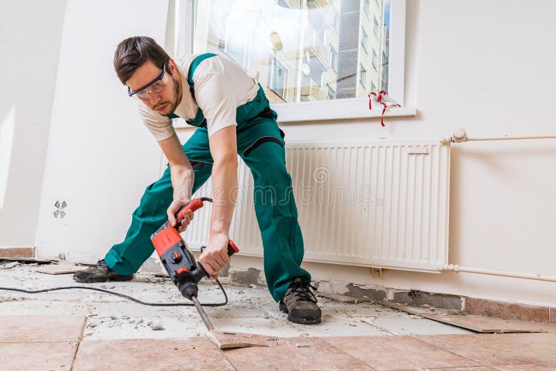 Demolition of old tiles with jackhammer. Renovation of old floor. Demolition of old tiles with jackhammer. Renovation of old floor.