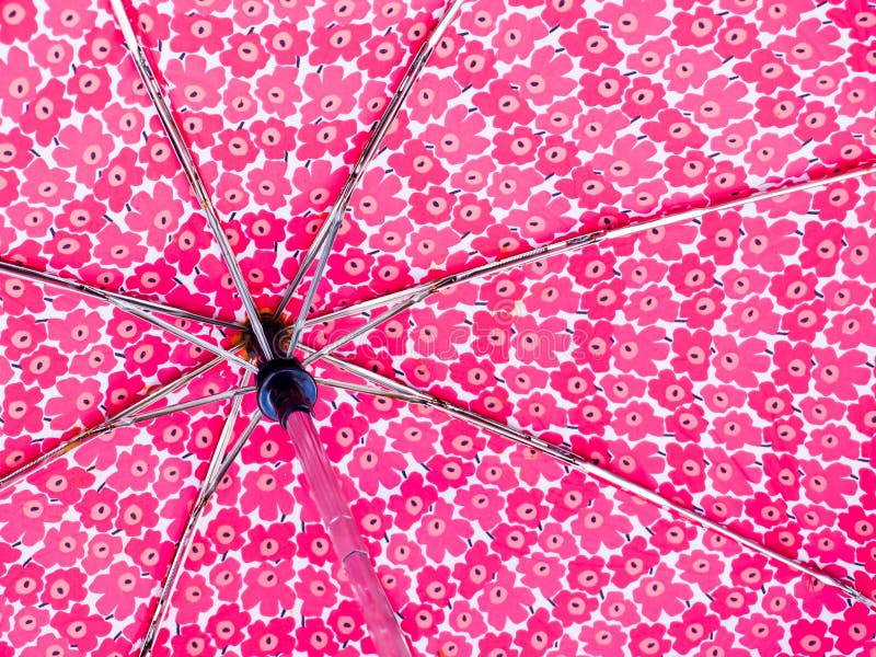 The underside of a flowery pink umbrella. The underside of a flowery pink umbrella.