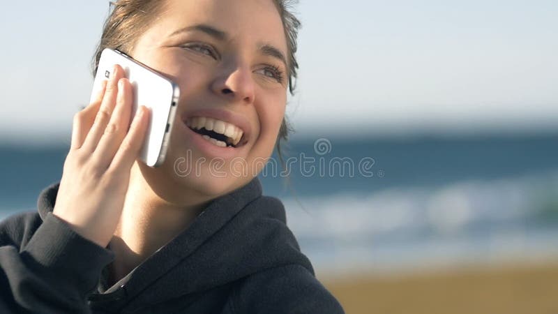 Roześmiana dziewczyna opowiada na telefonie uśmiecha się patrzeć szczęśliwy outdoors