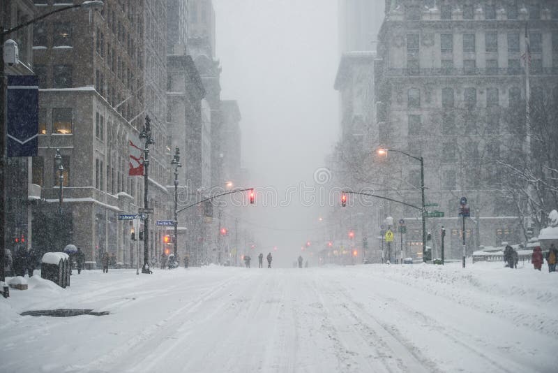 New York City Manhattan Midtown street under the snow during snow blizzard in winter. Empty 5th avenue with no traffic. New York City Manhattan Midtown street under the snow during snow blizzard in winter. Empty 5th avenue with no traffic.