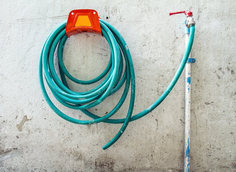 Rubber Hose Hanging the Cement Wall. Stock Photo Image of summer
