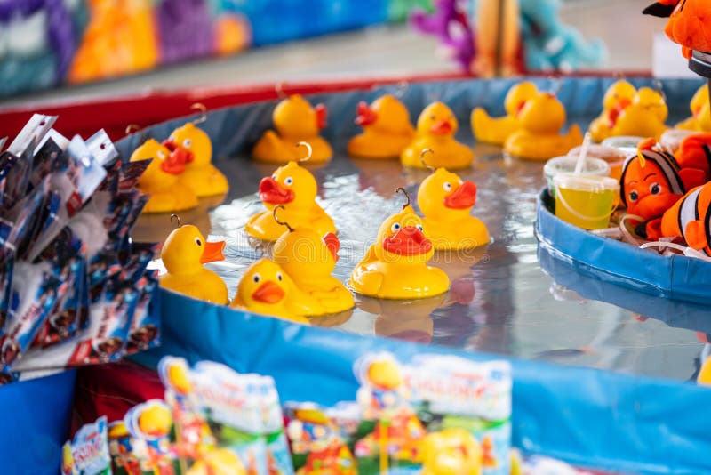 Rubber yellow ducks with hooks in their heads. Fairground hook a rubber duck chance game royalty free stock photos Rubber yellow ducks with hooks in their heads. Fairground hook a rubber duck chance game royalty free stock photos