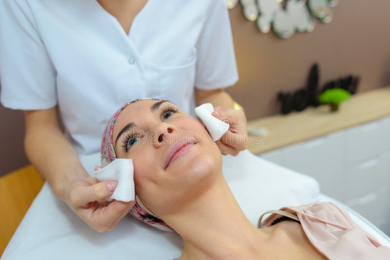 Rubbing face with cotton stock image. Image of solution 82890241