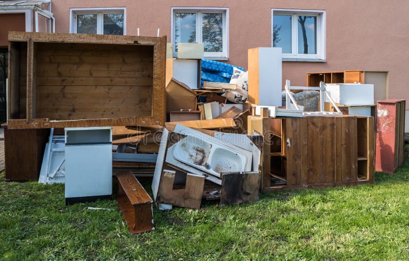 A Large Pile of Rubbish Under the Windows of a House Stock Photo