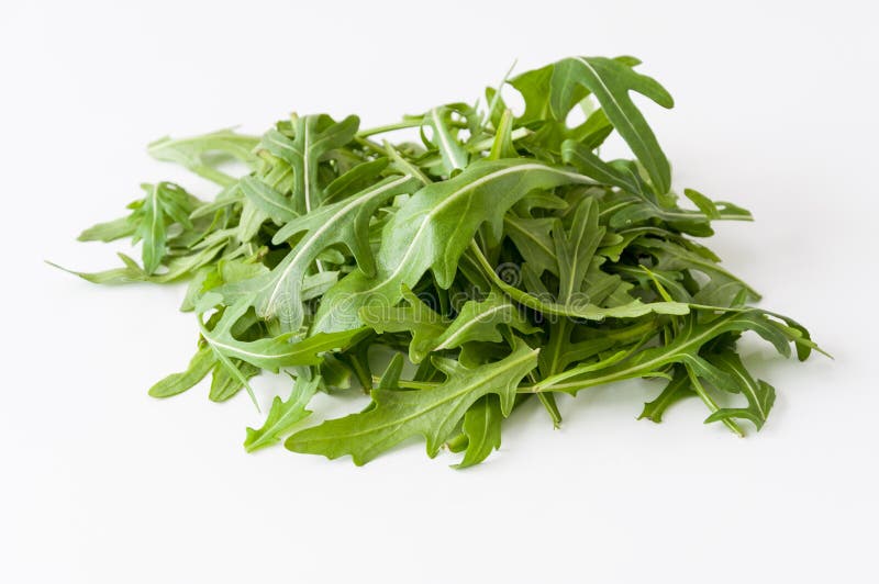 Fresh rucola lettuce on a white background. Fresh rucola lettuce on a white background