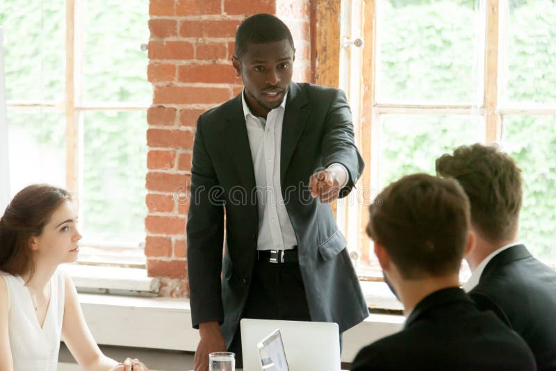 Rude african businessman pointing finger at white colleague duri stock photos Rude african businessman pointing finger at white colleague duri stock photos