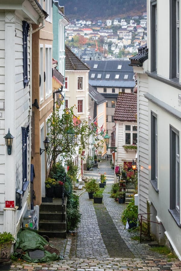 Narrow cobble stoned streets between old white traditional houses in the old part of Bergen town, Norway. Narrow cobble stoned streets between old white traditional houses in the old part of Bergen town, Norway