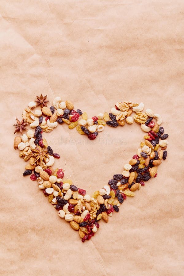 Aesthetic heart shaped assorted nuts, raisins and cranberries. Healthy food and snacks. Walnuts, almonds, hazelnuts and cashews. Aesthetic heart shaped assorted nuts, raisins and cranberries. Healthy food and snacks. Walnuts, almonds, hazelnuts and cashews