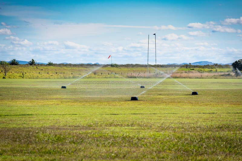 A Rugby and Soccer Fields Being Watered after a Game Stock Photo