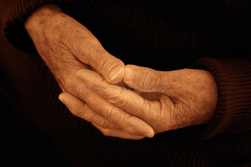 The hands of an 80 year old woman. blackand white sepia toned. The hands of an 80 year old woman. blackand white sepia toned.