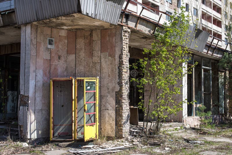 Ruined house with broken windows. The entrance, the exclusion zone, Pripyat, Chernobyl, Soviet architecture royalty free stock photo Ruined house with broken windows. The entrance, the exclusion zone, Pripyat, Chernobyl, Soviet architecture royalty free stock photo