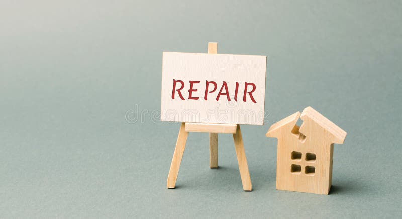 Ruined house and a poster with the word Repair. The concept of a damaged house, dilapidated housing. Home repair after disaster. Renovation, restoration of the old building. Property insurance. Damage