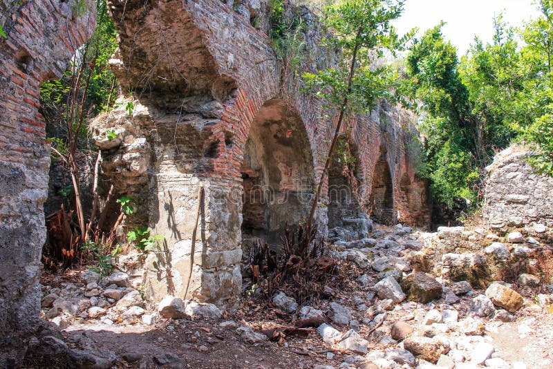 The Ruins Of An Ancient Greek City In Green Trees On The Mediterranean