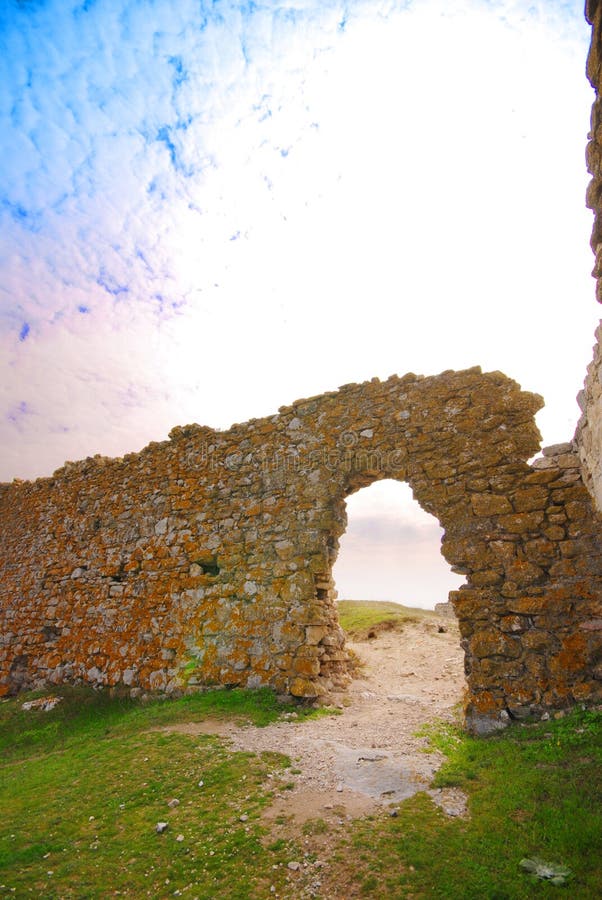 Enisala fortress (often referred to as Heracleea) is a 12th to 14th century medieval fortress. The picture shows the view of the ruins of one wall with a passageway through it. Enisala fortress (often referred to as Heracleea) is a 12th to 14th century medieval fortress. The picture shows the view of the ruins of one wall with a passageway through it.