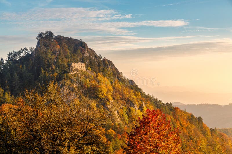 The ruins of the medieval Vrsatec castle at autumn sunset