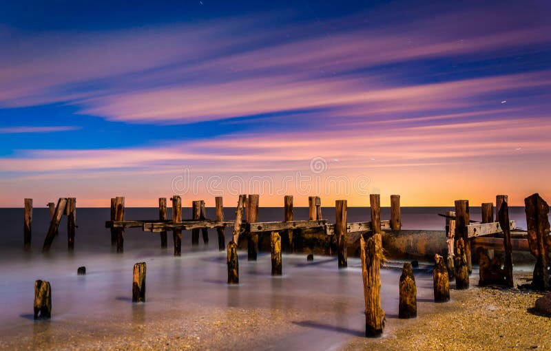 Ruins of an old pier on Sunset Beach at night, in Cape May, New