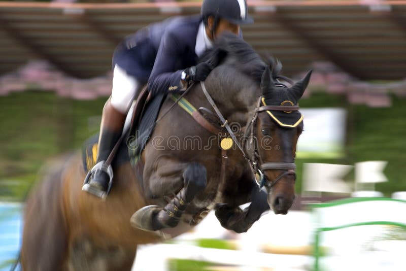 Image of an equestrian competitor in action with intentional blurring to portray speed. Image of an equestrian competitor in action with intentional blurring to portray speed.