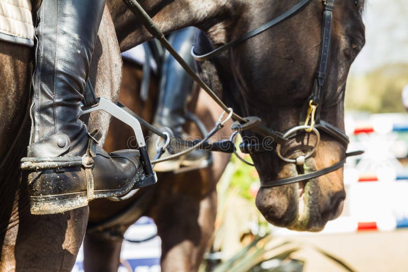 Equestrian Rider boots accessories closeup detail and horse show jumping close-up. Equestrian Rider boots accessories closeup detail and horse show jumping close-up