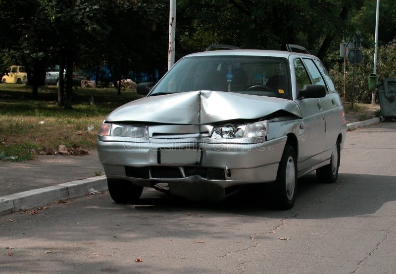 Wrecked car on a parking lot, frontal damage. Wrecked car on a parking lot, frontal damage