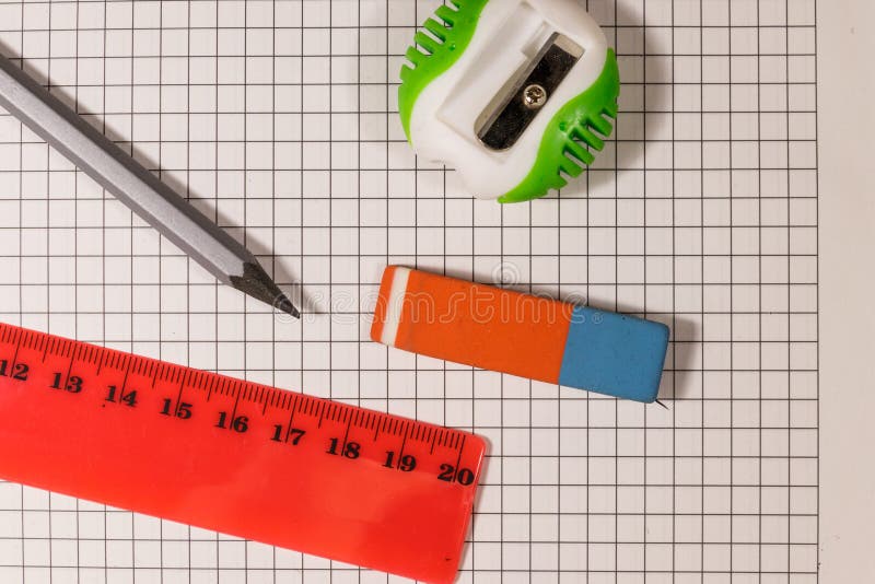 Ruler, Pencil, Sharpener and Eraser on Notepad Sheet Stock Image