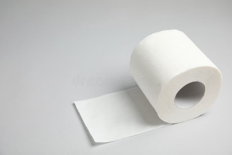 Rulle för toalettpapper på grå bakgrund royaltyfria foton Rulle för toalettpapper på grå bakgrund royaltyfria foton