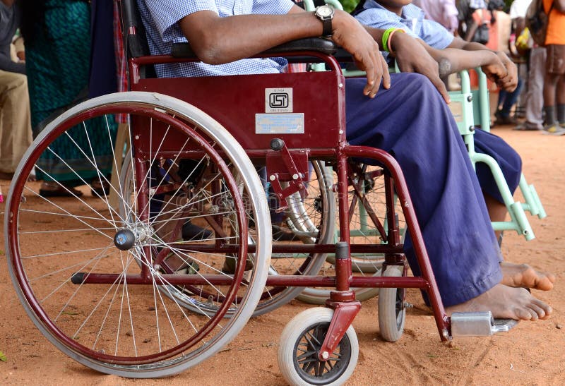 A disabled man sitting in a wheel chair. A disabled man sitting in a wheel chair