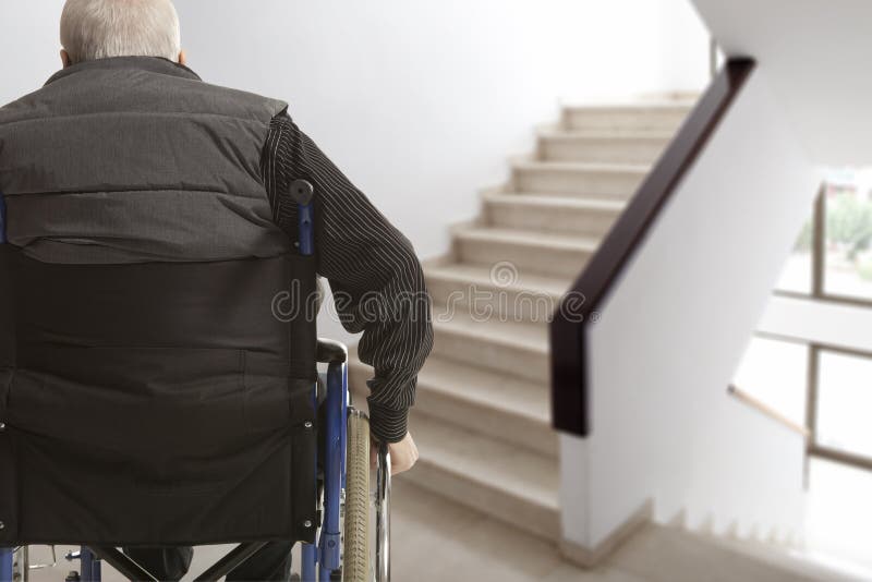 Wheelchair user in front of staircase barrier. Wheelchair user in front of staircase barrier