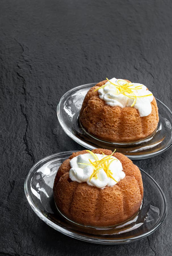 Rum Baba Decorated with Whipped Cream on Black Stone Background Stock