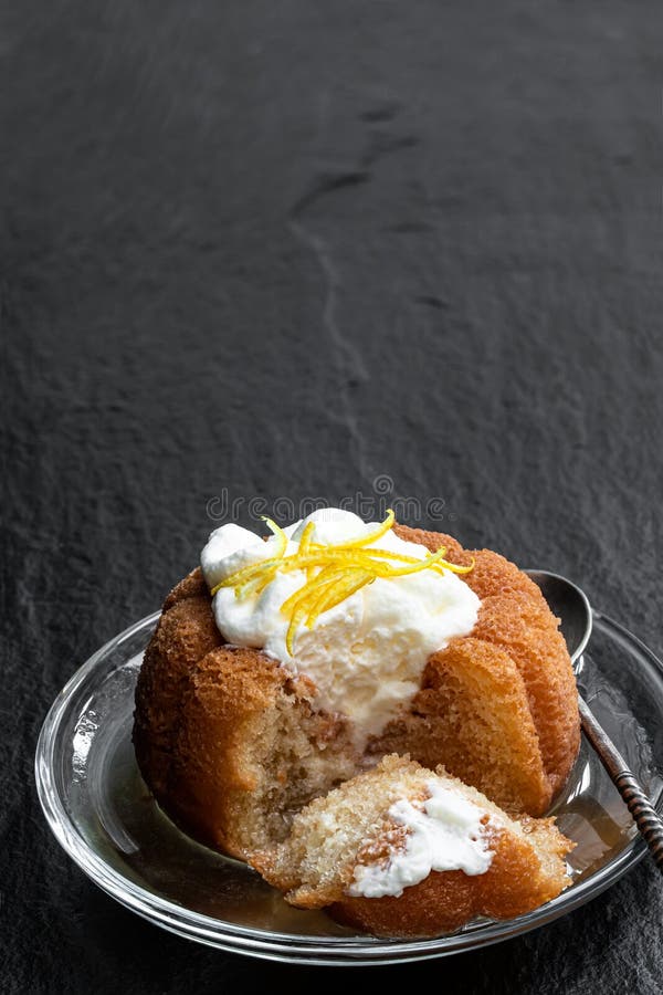 Rum Baba Decorated with Whipped Cream on Black Stone Background Stock