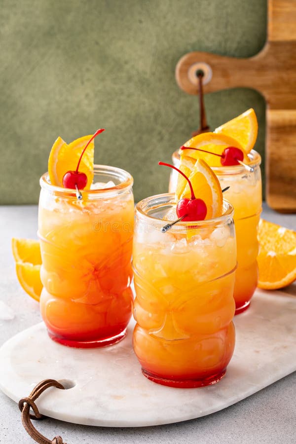 Rum Punch in Tiki Glasses with Orange Slices and a Cherry Stock Image