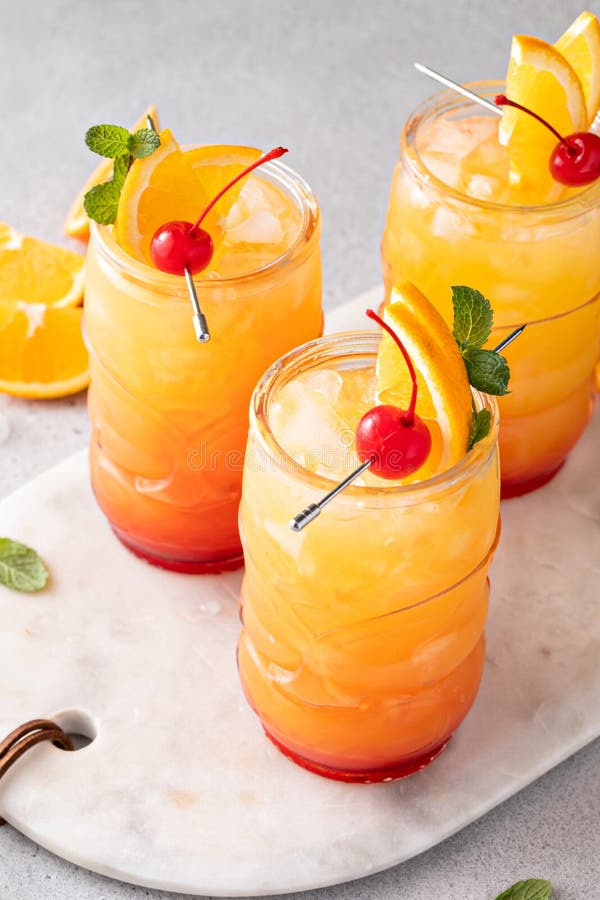 Rum Punch in Tiki Glasses with Orange Slices and a Cherry Stock Image