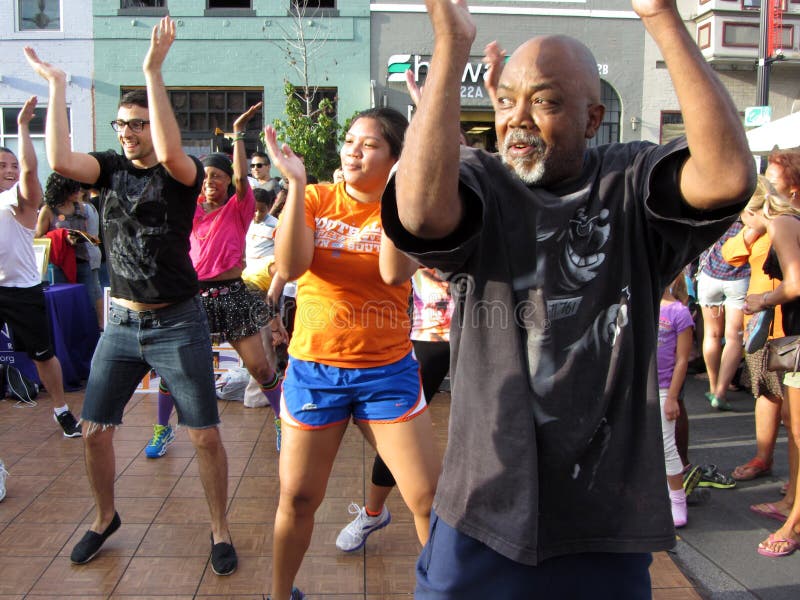 Photo of rumba dance group at the h street festival in downtown washington dc on 9/15/12. This festival takes place every year in mid september with food, arts and crafts, music, a parade, car displays, free health screenings and dance. The h street neighborhood is undergoing revitalization. Photo of rumba dance group at the h street festival in downtown washington dc on 9/15/12. This festival takes place every year in mid september with food, arts and crafts, music, a parade, car displays, free health screenings and dance. The h street neighborhood is undergoing revitalization.