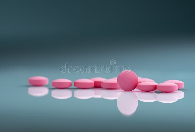 Runde rosa Tablettenpille auf Steigungshintergrund Vitamine und Mineralien plus Fols? urevitamin E und Zink lizenzfreie stockfotos