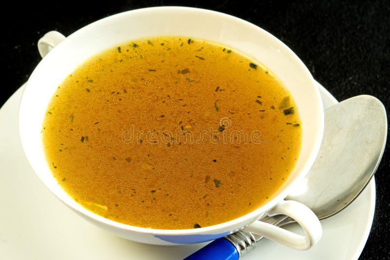 Beef broth on a black background. Beef broth on a black background