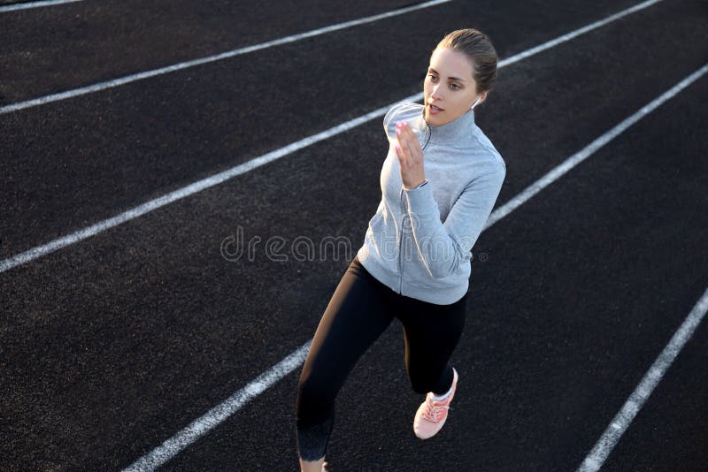 Runner Athlete Running on Athletic Track Training Her Cardio in Stadium