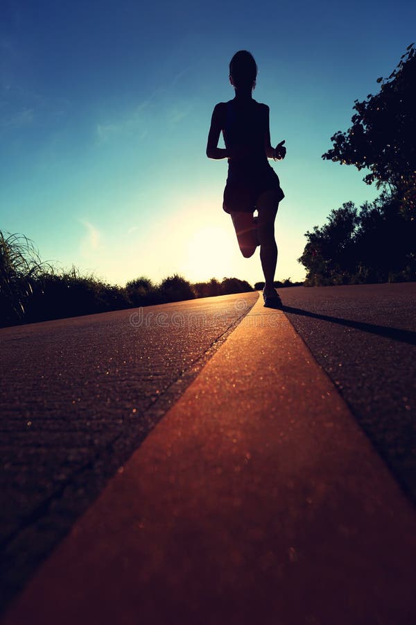 Runner athlete running at seaside road